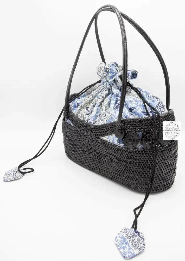 Black boat bag with top handles, blue-white drawstring lining